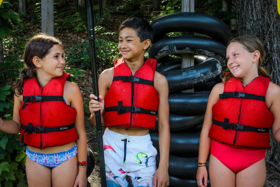 Campers in lifejackets getting ready for kayaking