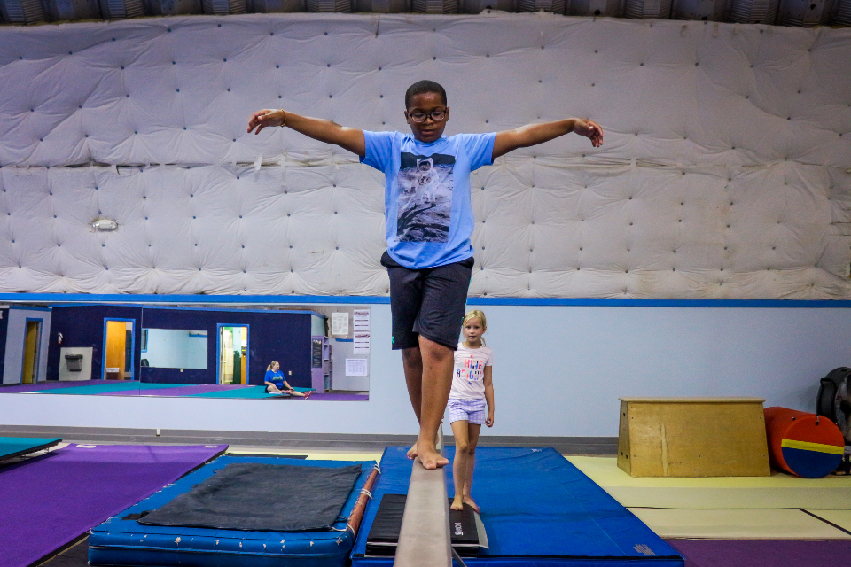 Young camper practicing his balance at coed summer camp