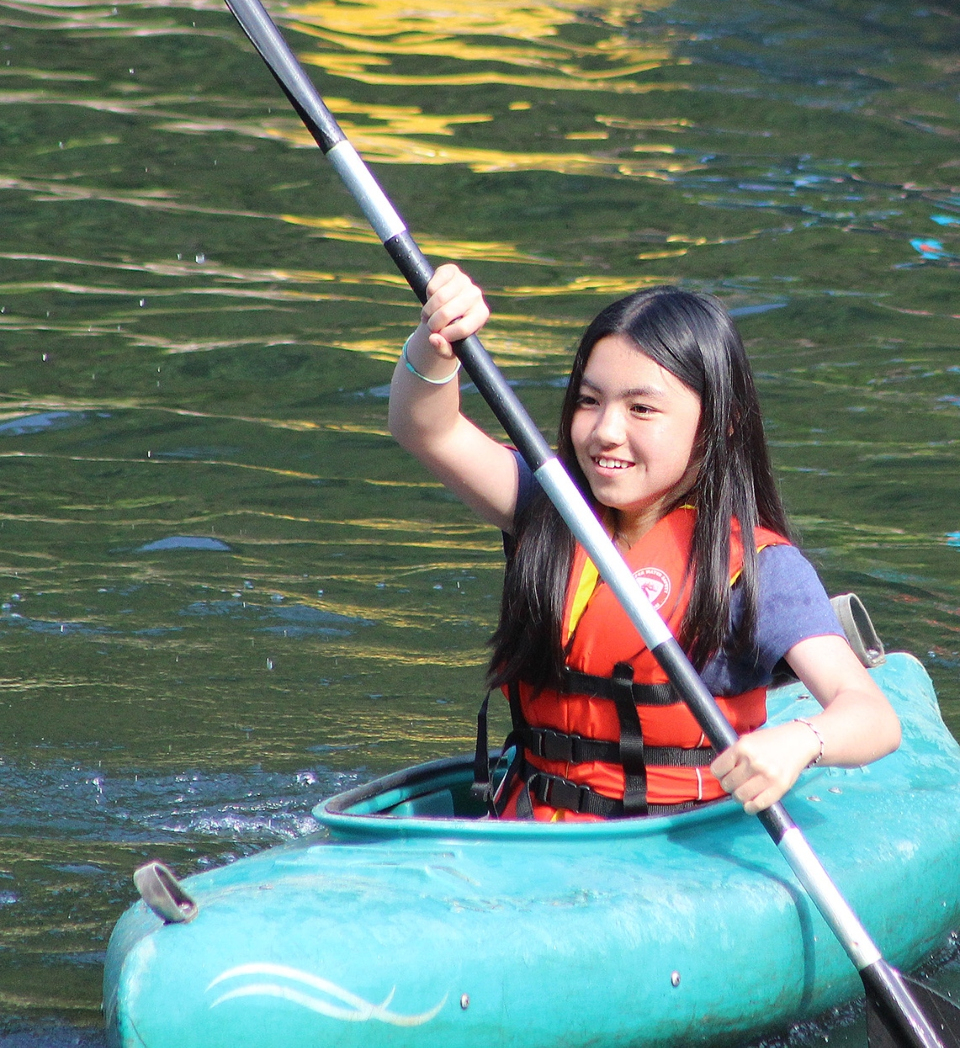 Girl kayaking at Camp Friendship coed summer camp