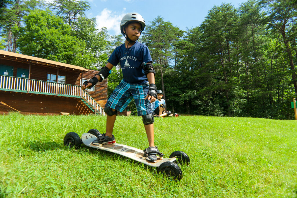 Young boy Mountain Boarding at an overnight camp
