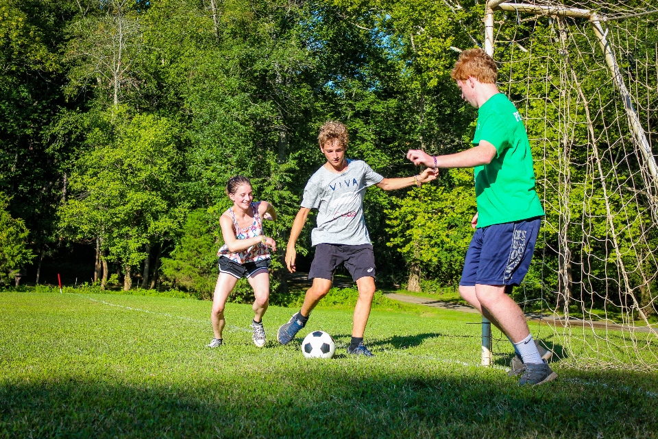 Counselor teaches campers about soccer at Camp Friendship summer camp