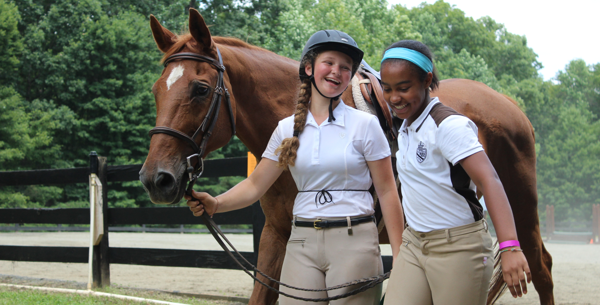 Two Equestrian campers walk with a horse at the Camp Friendship Horse Show