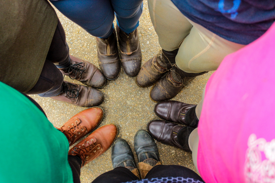 Our horseback riding camp teens show of their riding boots.
