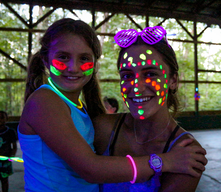 Girl camper and girl counselor having fun at the dance at sleep-away camp 