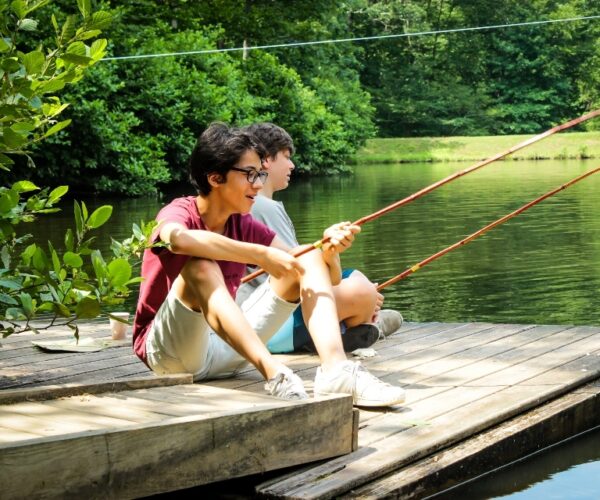 Two senior campers relax and fish off of one of our floating docks.