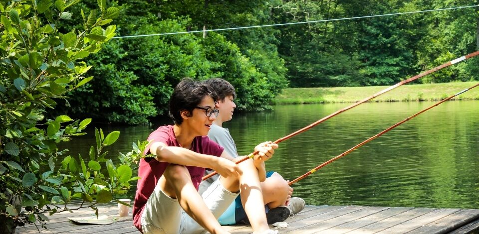 Two senior campers relax and fish off of one of our floating docks.