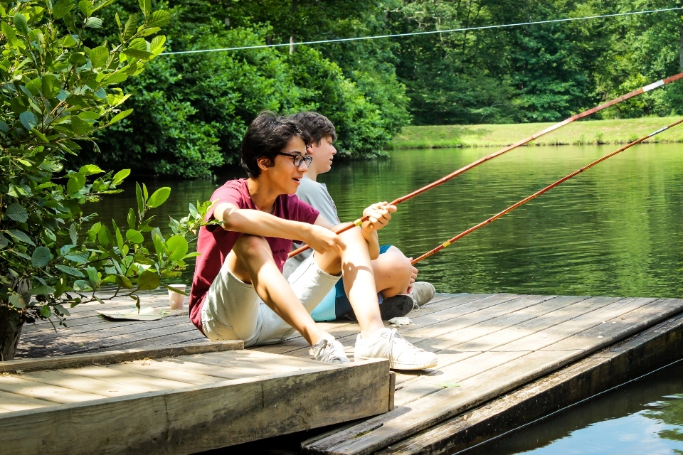 Two senior campers relax and fish off of one of our floating docks.