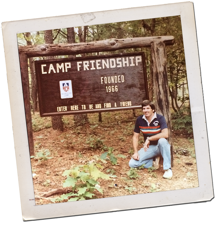 Camp Friendship founder Chuck Ackenbom in front of original sign in the 1960s