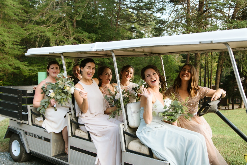 The bride and bridesmaids prepare to head to the ceremony in our stretch golf cart, availible for camp weddings and camp retreats.