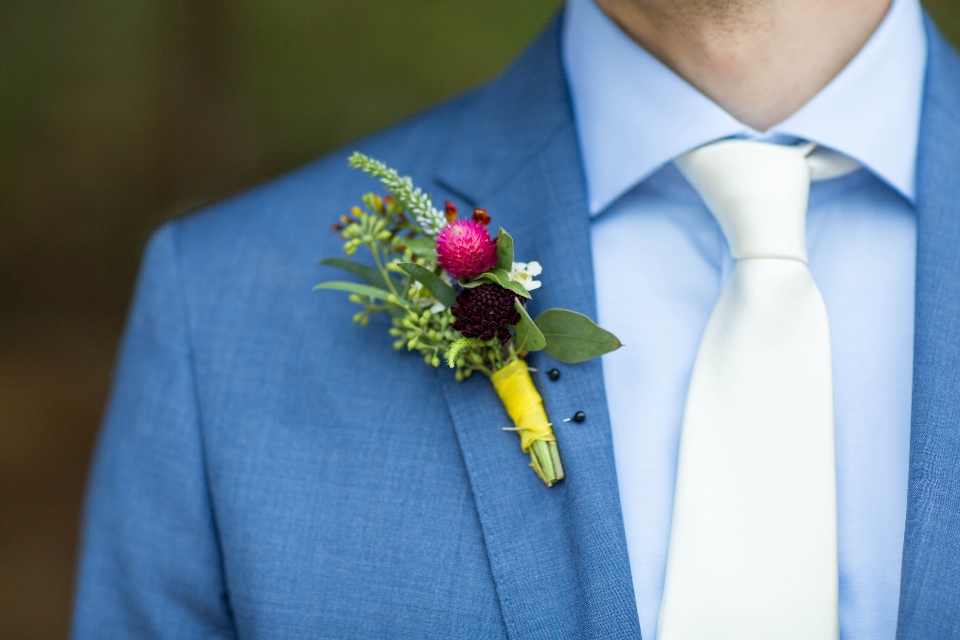 Colorful Boutonniere pinned to groom's jacket