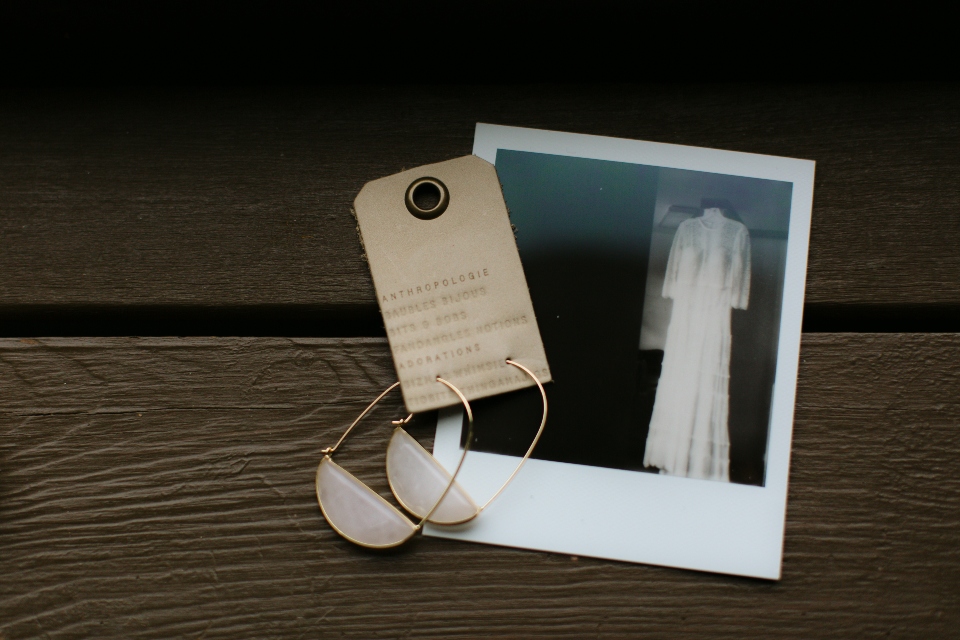 A picture of a Polaroid and earrings, to keepsakes from this camp wedding.
