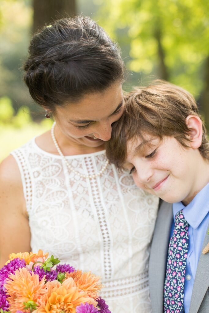 A brie takes a picture with her happy son after the ceremony.