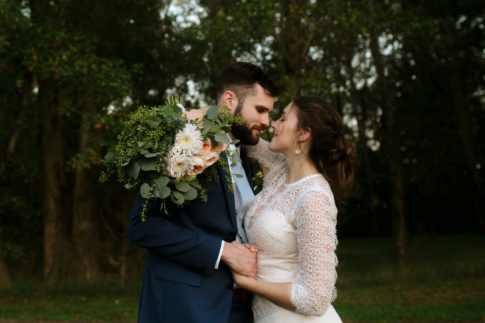 Bride and Groom hold each other with beautiful bouquet