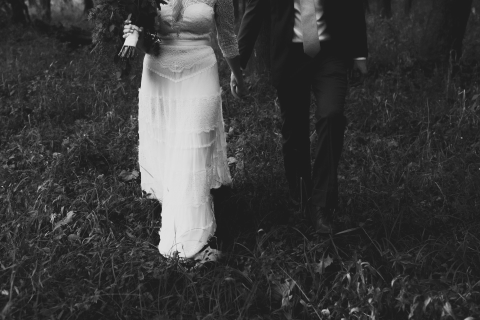 Bride and Groom walking hand-in-hand through the wilderness at their outdoor virginia wedding