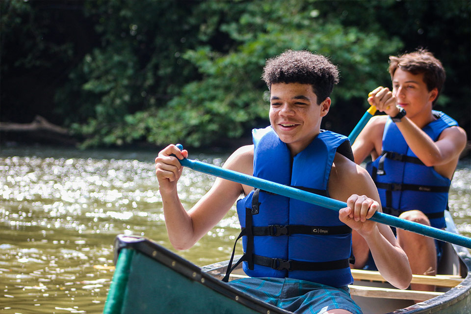 Teen boy campers canoeing at Camp Friendship in Virginia