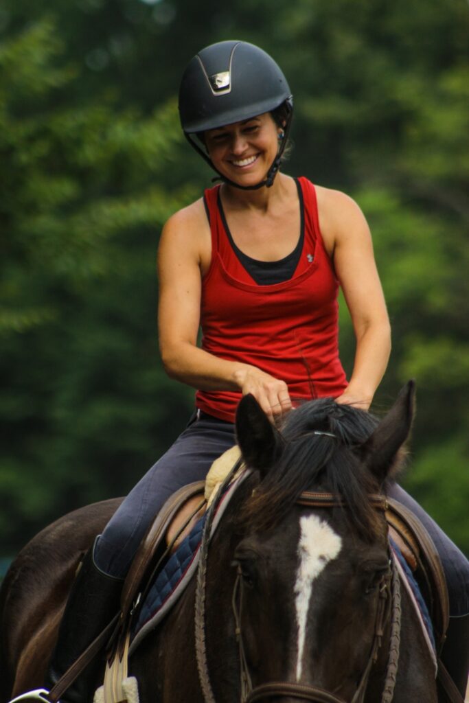 Director Sarah Ackenbom riding a horse to prepare us for our overnight equestrian summer camp.