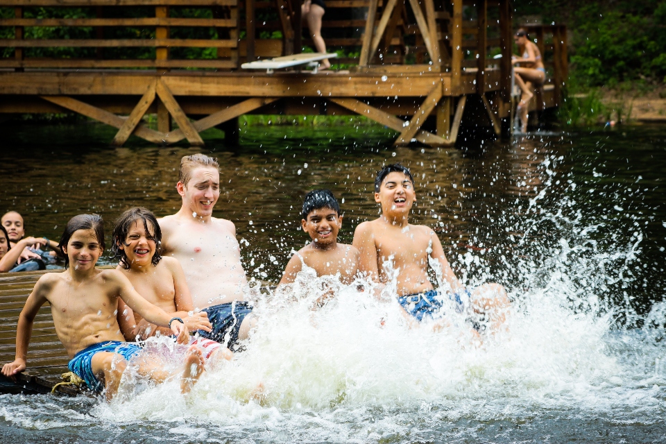 Junior Boy campers and their cabin counselor forget all about video games and apps as they create a new game, moving the floating dock with teamwork!