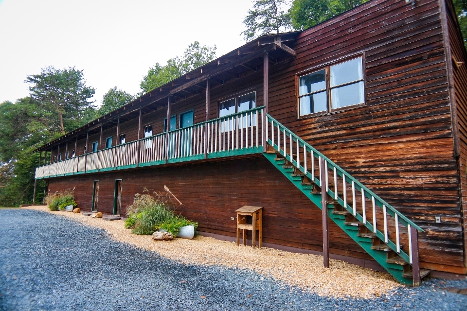 Long wooden two story building with stairs to second floor suites for wedding guest lodging