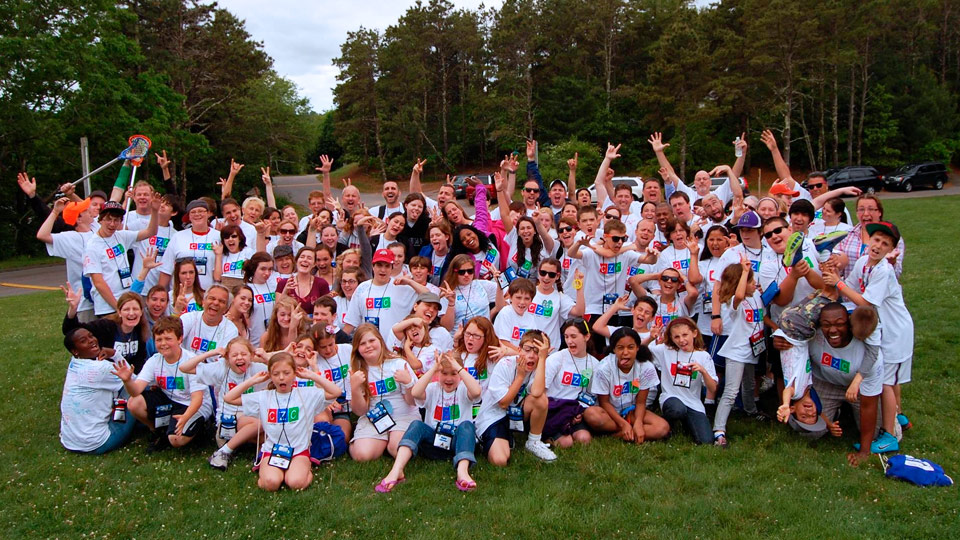 Comfort Zone Camp poses for group photo outside