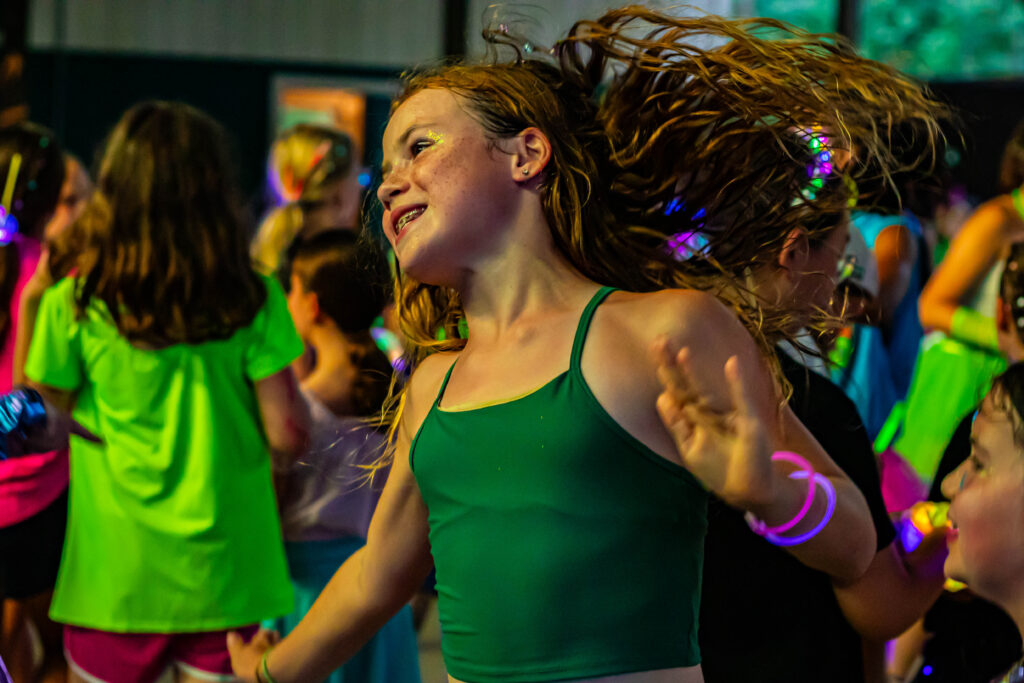 One girl smiling and whipping her hair