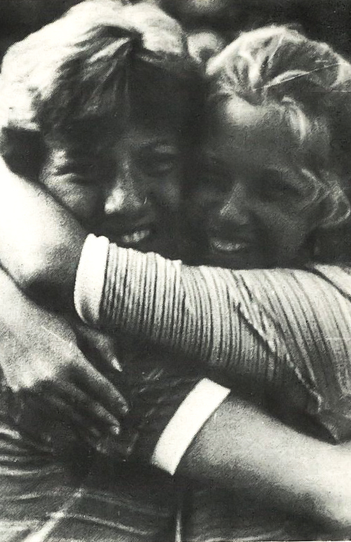 A black and white photo of two women hugging